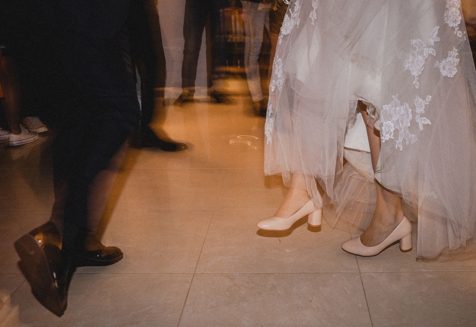 Long exposure of a white dress moving across a dance floor.